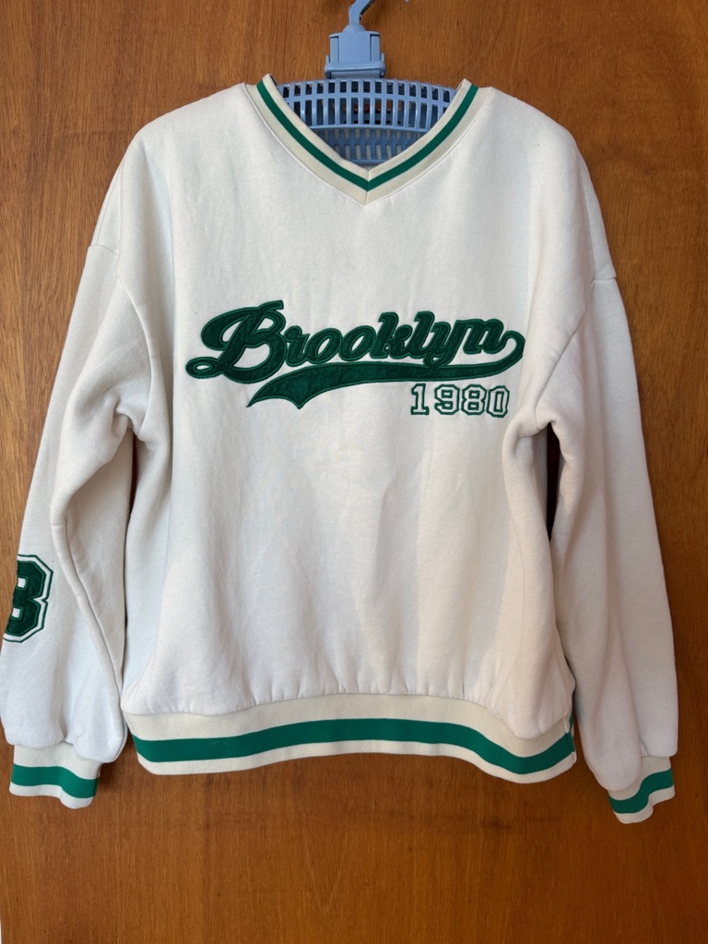 Edikted Cream V-Neck Sweater with Green Brooklyn 1980 Appliqué